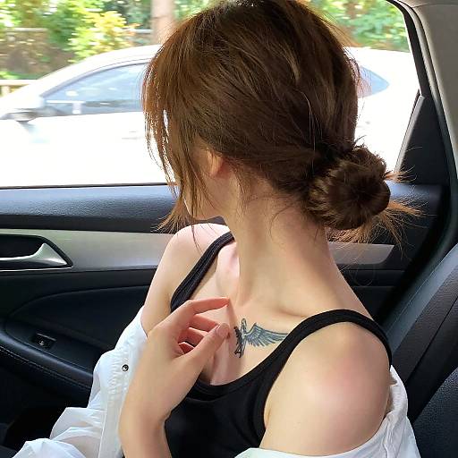 Woman with Angel Wings Tattoo in Car