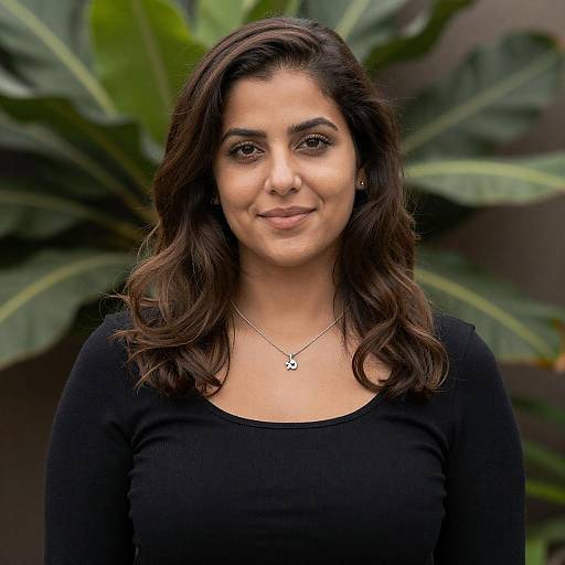 Smiling woman with wavy hair and silver necklace