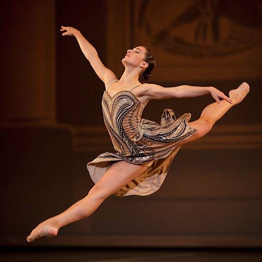Photograph of a female ballerina mid-leap, wearing a sparkling, black and gold sequined dress, arms and legs gracefully extended, against