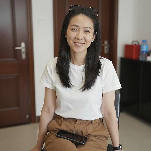 Smiling Asian Woman Sitting Indoors