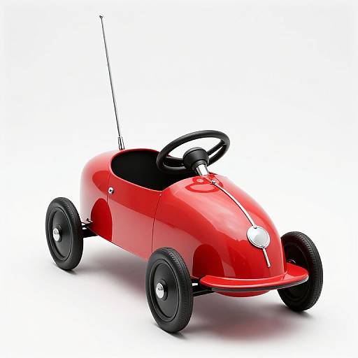 Photograph of a sleek, shiny red toy car with black wheels, a black steering wheel, and an antenna, set against a white background.