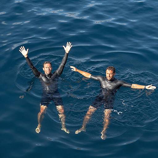 Men in Wetsuits on Blue Water Surface