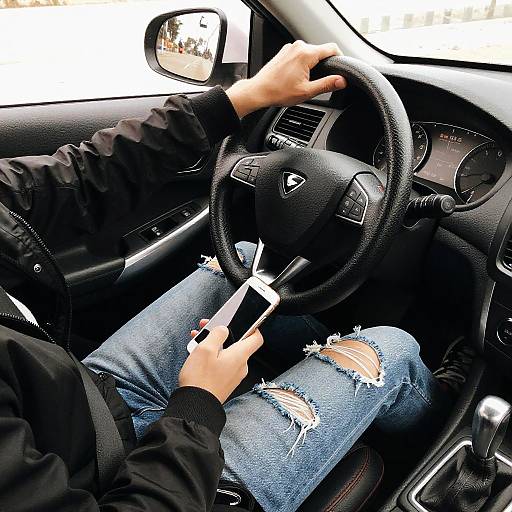 Person in Dark Car with Smartphone