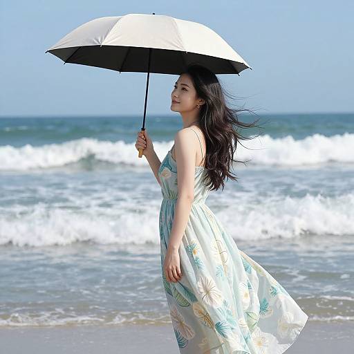 Photograph of an Asian woman with long black hair, wearing a flowing white dress with green patterns, holding a black-and-white umbrella, standing on a