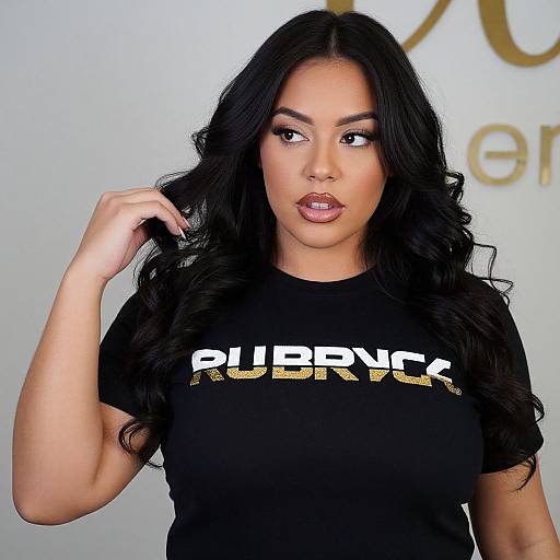 Photograph of a Latina woman with long black hair, wearing a black 