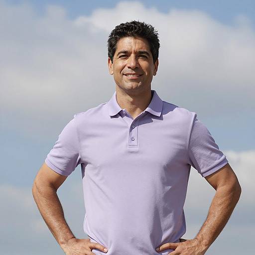 Smiling Man in Polo Shirt Against Sky