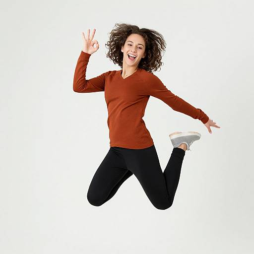 Joyful Young Woman Mid-Jump Pose