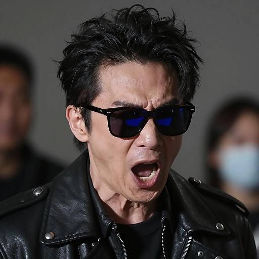 Intense Man in Leather Jacket and Dark Sunglasses