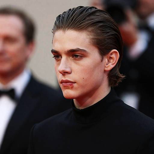 Young Man with Slicked-Back Hair and Black Collar Shirt