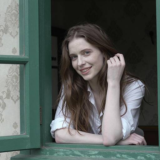 Smiling Woman Leaning on Green Window Frame