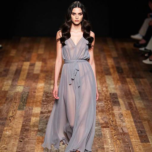 Elegant Woman in Flowing Chiffon Dress on Wooden Stage