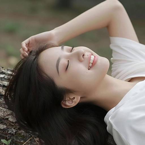Smiling Girl Relaxing Under a Tree