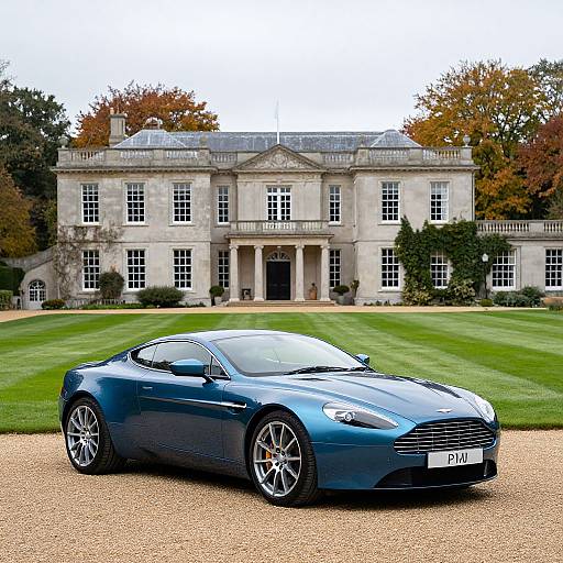 Photograph of a sleek, blue Aston Martin parked on a gravel driveway in front of a grand, white stone mansion with large windows and manicured lawn