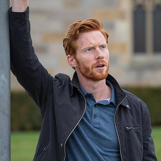 Focused Red-Haired Man in Outdoor Scene