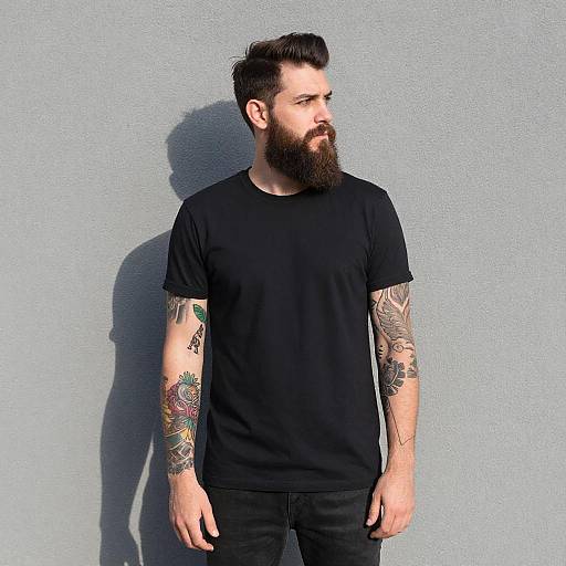 Thoughtful Bearded Man Against Gray Wall