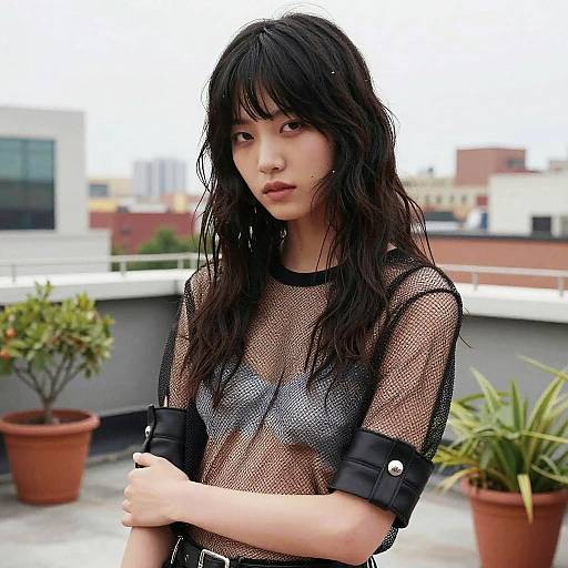 Female Model with Mullet Hairstyle in Mesh Top on Urban Rooftop