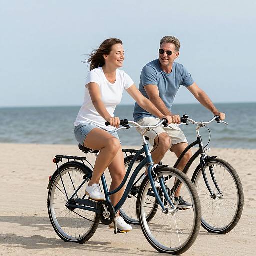 Happy Mature Couple Biking on Beach