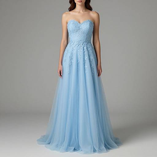 Photograph of a slender woman with light skin wearing a strapless, light blue, lace-embellished, full-length wedding gown with a flowing