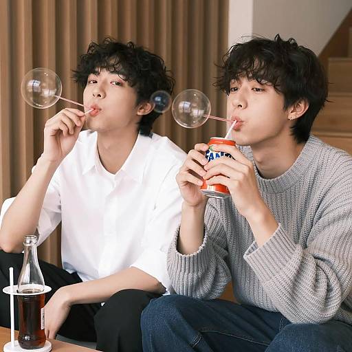 Young Men Playfully Blowing Bubbles