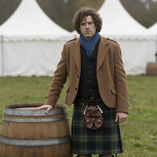 Serious Man in Plaid Kilt Beside Barrel