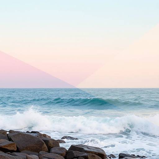 Photograph of a rocky shoreline with foamy waves crashing against dark rocks under a pastel pink and blue sky at sunset.