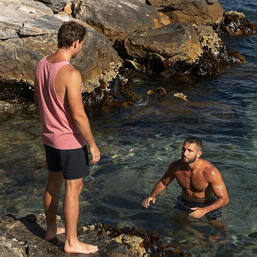 Couple by Rocky Shore at Sunset