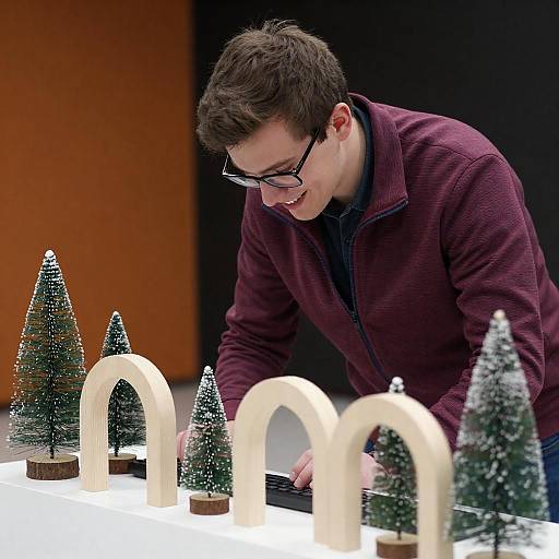 Young Man Working on Holiday-Themed Setup