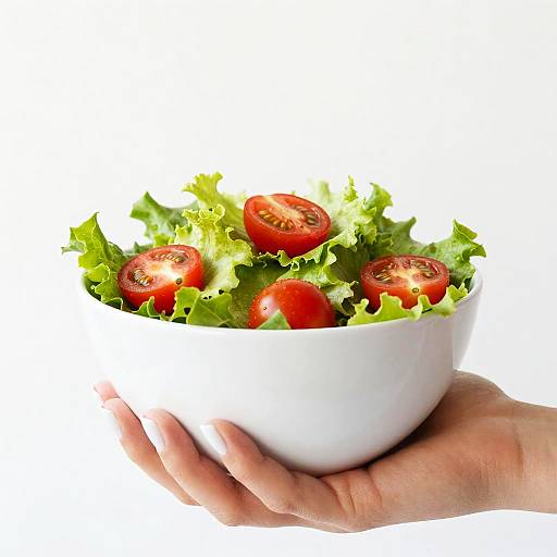 Hand Holding Fresh Salad Bowl