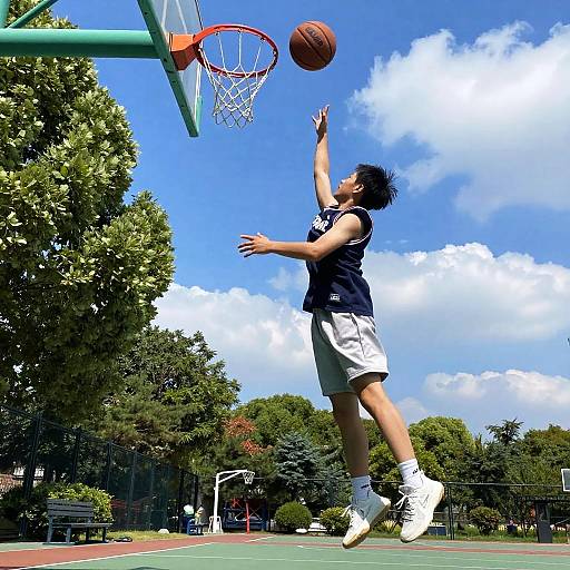 Young Boy Leaping for Basketball Shot