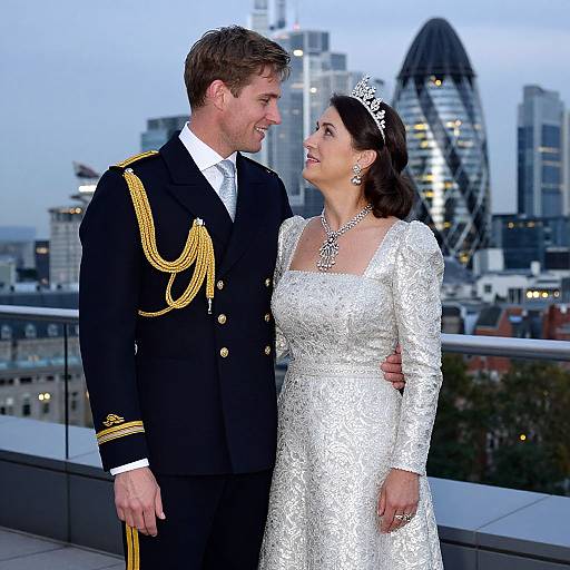 Photograph of smiling bride in white lace dress and tiara, and groom in black military uniform with gold epaulettes, standing on rooftop with