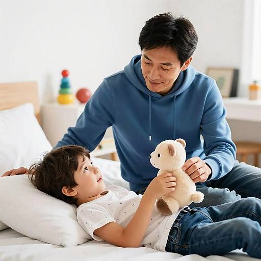 Father and Son Playing with Teddy Bear in Bedroom