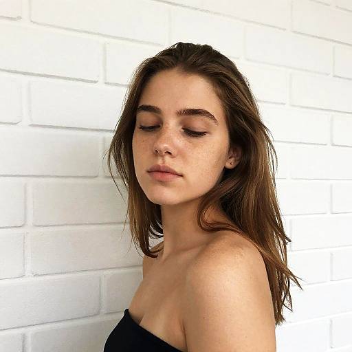 Relaxed Young Woman Against White Wall