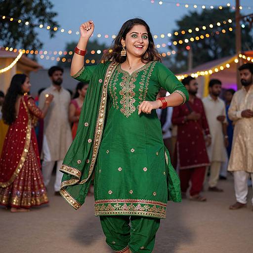 Photograph of a smiling Indian woman in a green traditional kurti with gold embroidery, dancing at an evening festival, surrounded by string lights and people