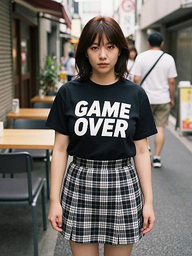 Photograph of an Asian woman with shoulder-length black hair, wearing a black 