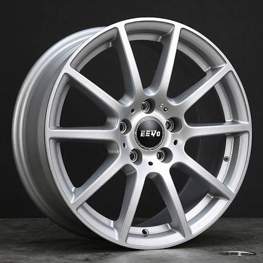 Photograph of a shiny, silver HRE wheel with 10 spokes, illuminated by internal lights, against a dark background.