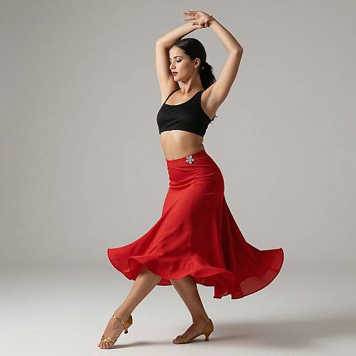 Photograph of an Asian woman with black hair, wearing a black crop top and red skirt, dancing with arms raised, against a plain white background.