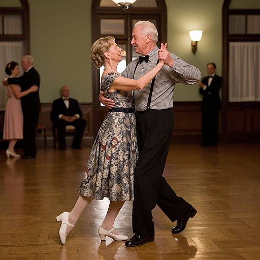 Photograph of an elderly couple dancing in a dimly lit ballroom, wearing formal attire; the woman in a floral dress, the man in a