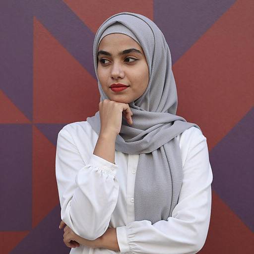 Young Woman in Gray Hijab by Colorful Wall