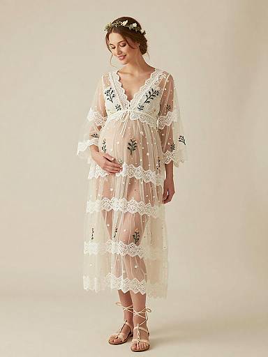 Pregnant Woman in Sheer Lace Maternity Dress