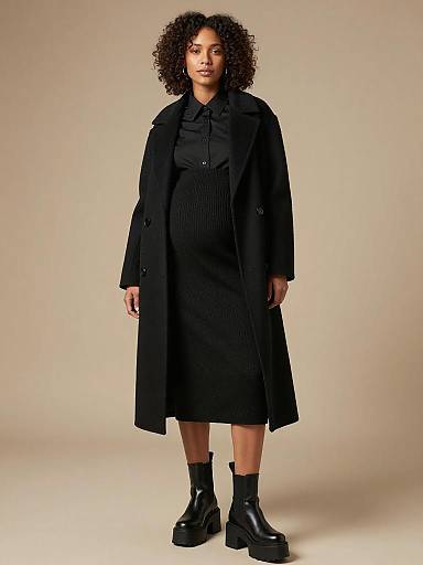 Pregnant Woman in Elegant Black Maternity Fashion