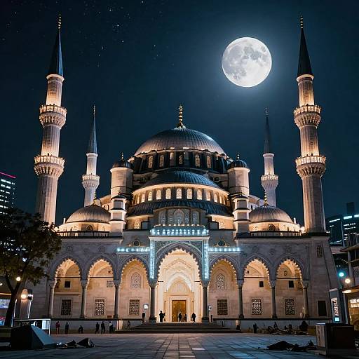 Photograph of a brightly lit, grand mosque at night with a full moon in the dark sky, highlighting its domes and minarets. Sil
