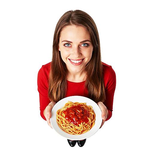 Photograph of a smiling young woman with long brown hair, blue eyes, and red shirt, holding a white plate of spaghetti with red sauce, viewed