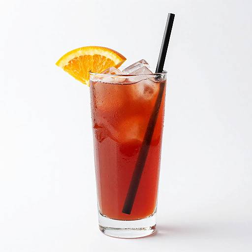 Photograph of a tall, clear glass filled with a dark red iced drink, garnished with an orange slice, ice cubes, and a black