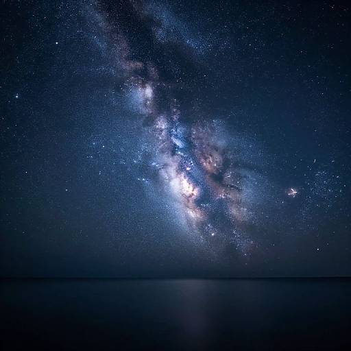 Photograph of a mesmerizing night sky showcasing the Milky Way galaxy, with vibrant blue and white stars, glowing celestial clouds, and a dark, reflective