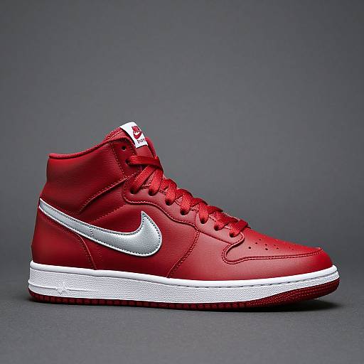 Photograph of a vibrant red high-top Nike sneaker with white Nike swoosh, white midsole, and red laces on a dark gray background