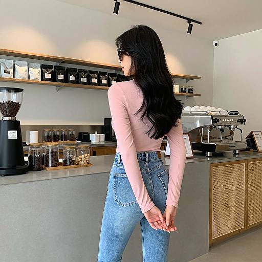 Woman in Pink Top and Jeans at Coffee Shop