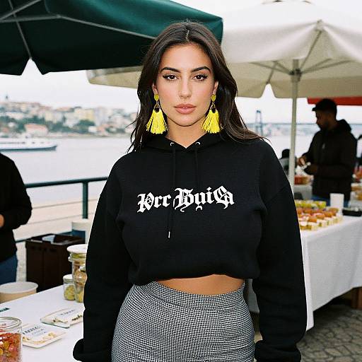Photograph of a young woman with long dark hair, wearing a black 
