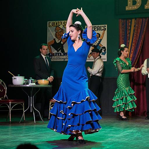 Photograph of a flamenco dancer in a blue ruffled dress, arms raised, center stage, with another dancer in green, and two men in