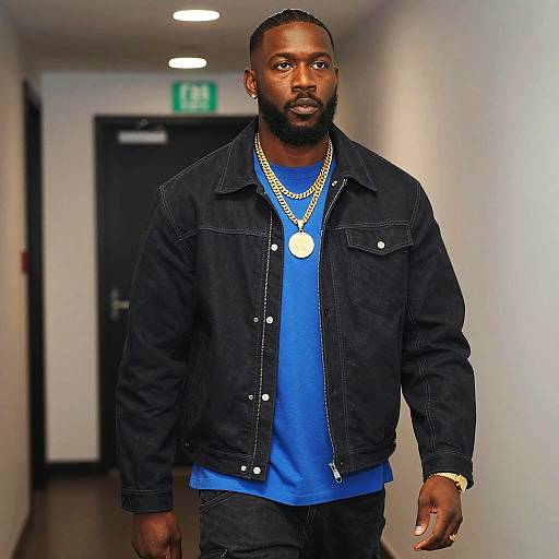 Stylish Man in Dark Jacket and Gold Chains Walking