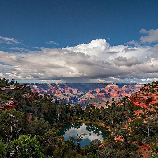 Photograph of Grand Canyon landscape: vibrant red rock formations, lush green trees, reflective water pool, bright blue sky with white clouds.